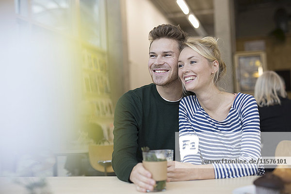 Couple sitting with herbal tea in cafe