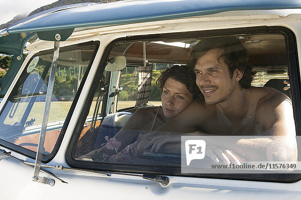 View through windscreen of couple in campervan