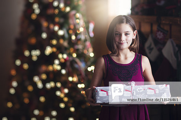 Young girl holding christmas gift