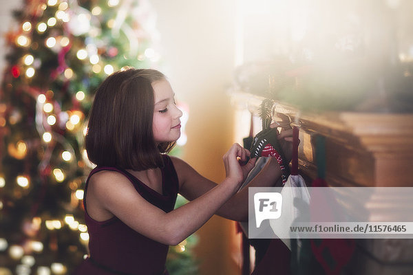 Young girl looking at christmas stocking