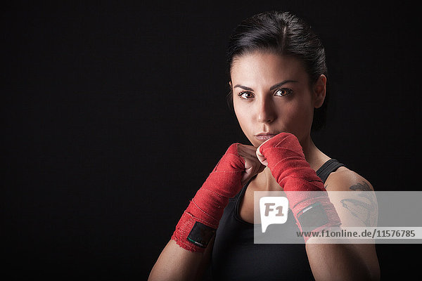 Portrait of young woman in fighting stance