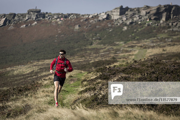 Male runner running near Stanage Edge  Peak District  Derbyshire  UK