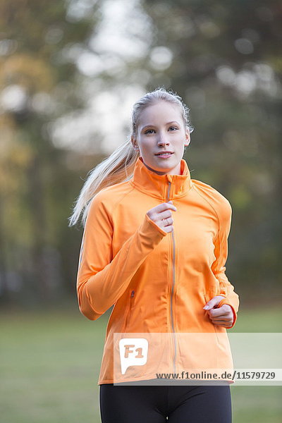 Pretty blonde woman doing jogging in park