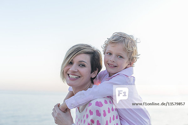 Portrait of a cute little boy with mum smiling at camera