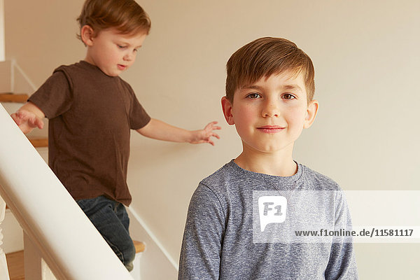 Portrait of boy and toddler brother on stairs