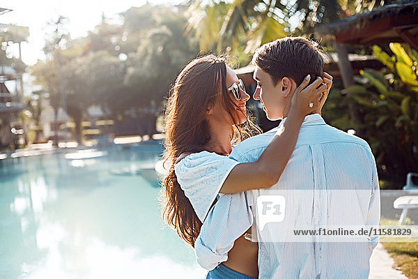 Romantic young couple embracing at poolside  Koh Samui  Thailand