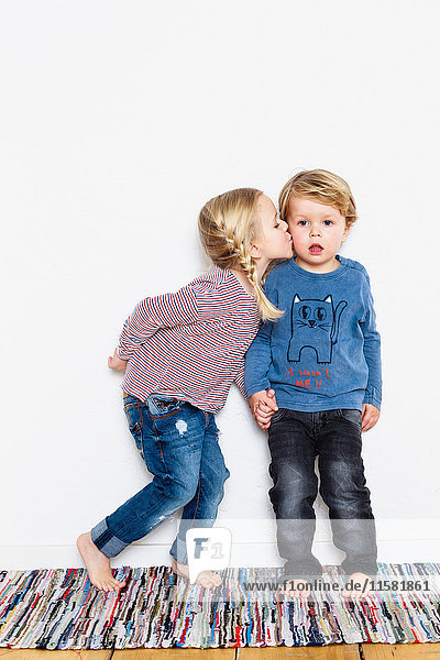 Young girl kissing young boy on cheek