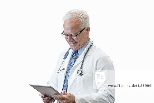 Senior male doctor with digital tablet  studio shot.