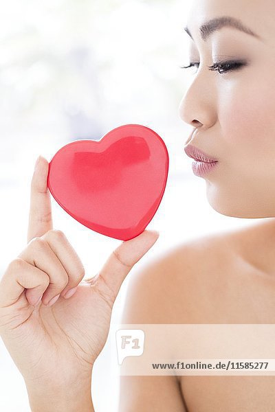 MODELL FREIGEGEBEN. Junge asiatische Frau mit Herz  Porträt.