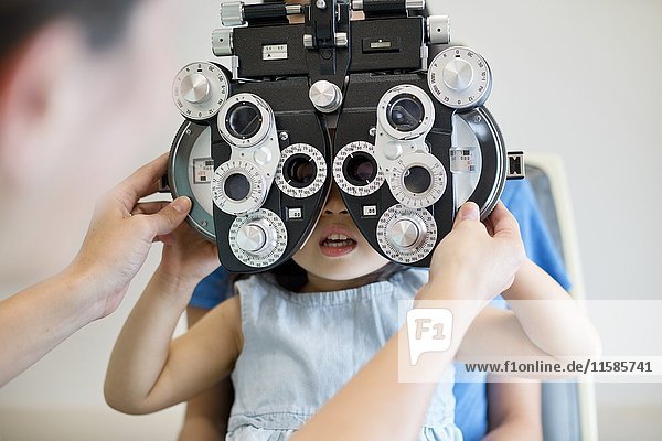 Girl having her eyes tested.
