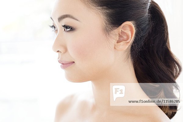MODEL RELEASED. Young Asian woman looking away  portrait.