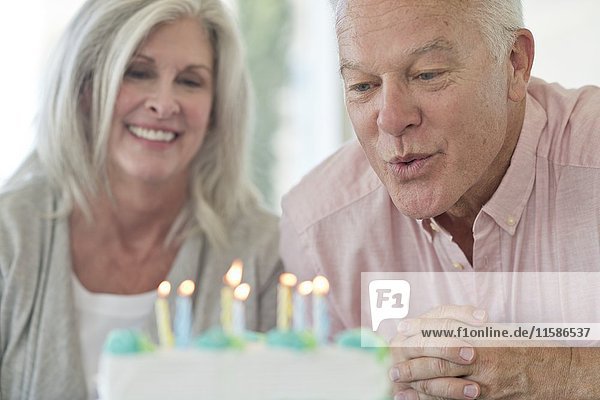 Senior couple with birthday cake.