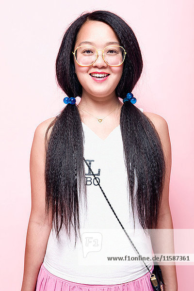 Woman with crimped pigtails and big glasses