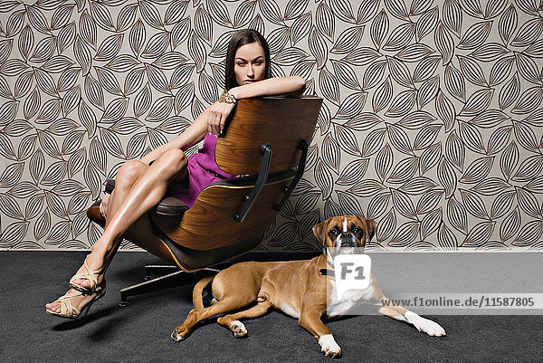 Woman sitting on chair with dog