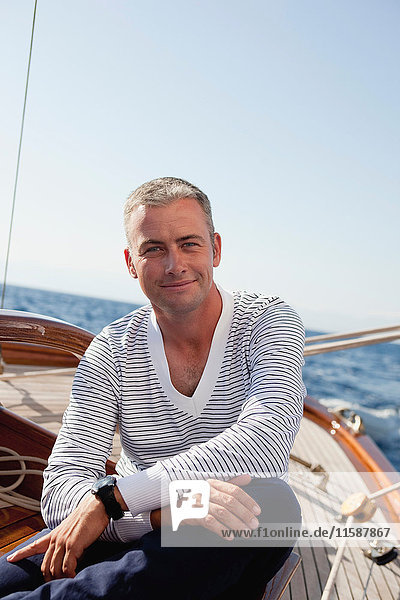 man smiling sitting on deck
