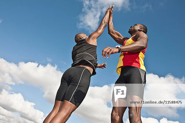 2 männliche Athleten springen mit hohen 50er Jahren