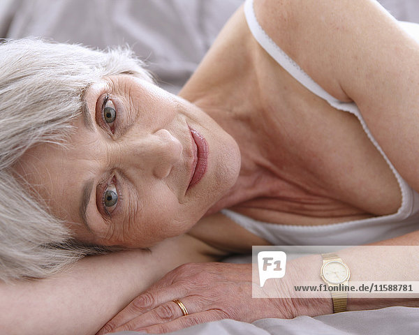 Senior woman relalxing on bed  smiling