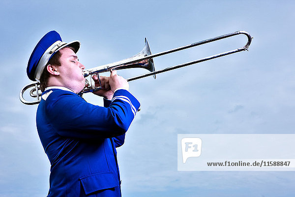 Portrait of young man playing trombone