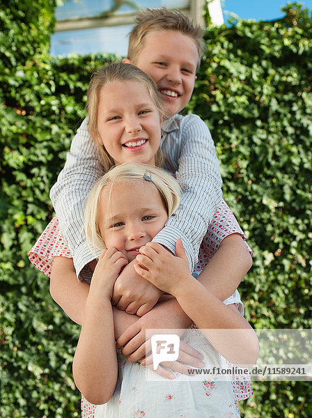 Boy and two sisters smiling  portrait