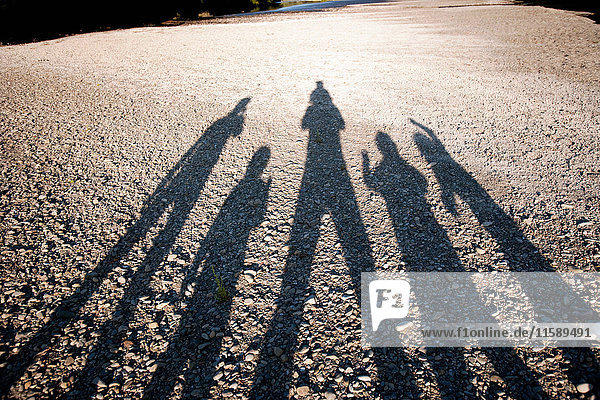Shadow of family on ground