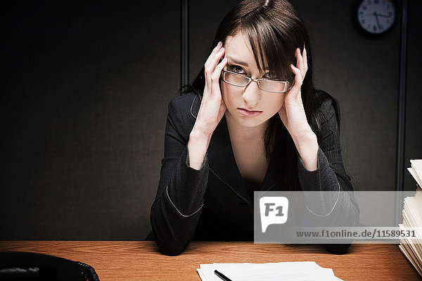 Stressed businesswoman at desk