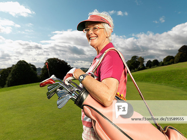 Mature lady playing golf