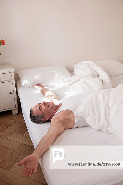 man lying on bed relaxing