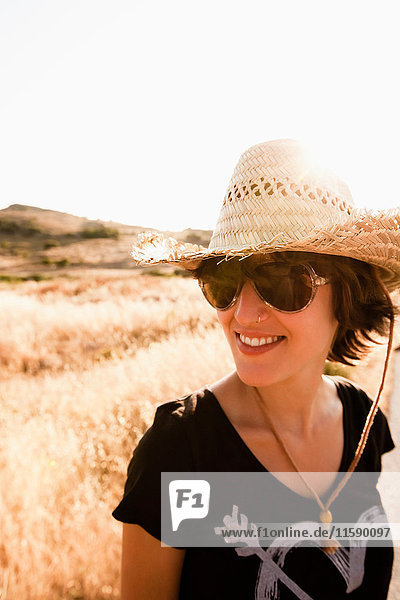 Smiling woman standing in wheatfield