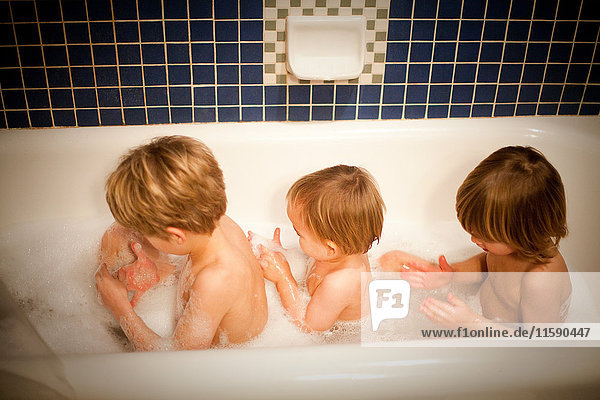 Three boys having bath together