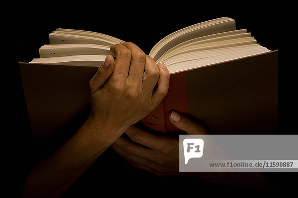 Hands holding book