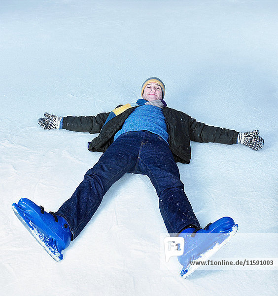 Man lying flat on his back on ice