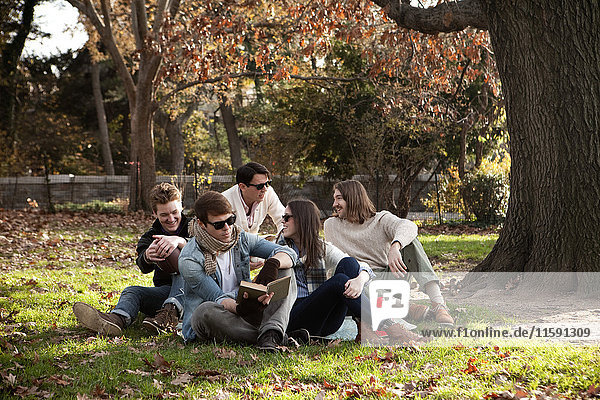 College friends relaxing in park