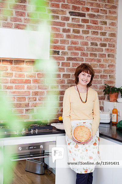 woman in kitchen smiling at viewer
