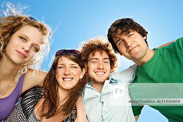 Portrait of four young happy people
