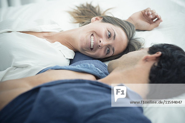 Smiling young couple in love lying down
