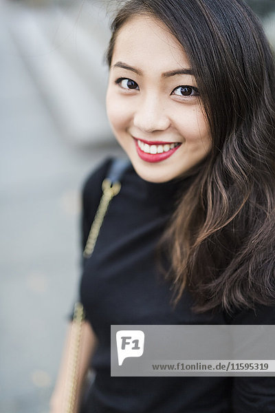 Portrait of smiling young woman dressed in black