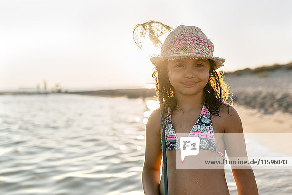 Spain  Menorca  portrait of a girl with a dip net on the beach