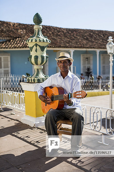 Cuba  Trinidad  man playing guitar on the street