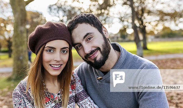 Portrait of happy couple in autumnal park