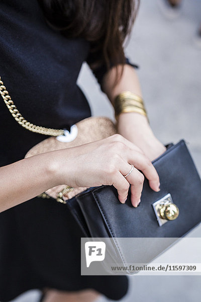 Woman's hand holding handbag