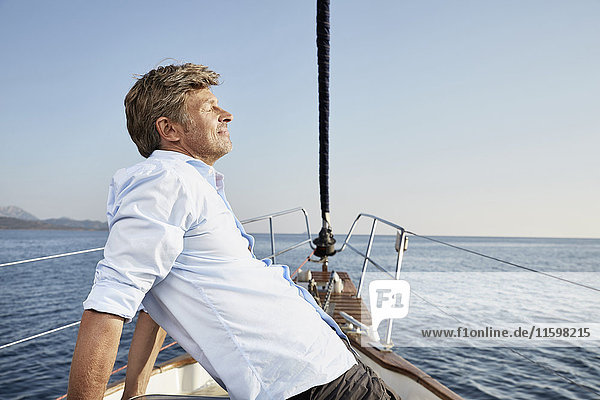 Mature man relaxing on his sailing boat
