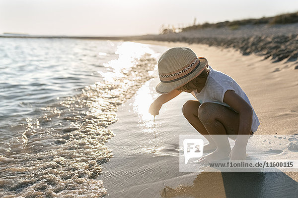Spain  Menorca  little girl playing on the beach