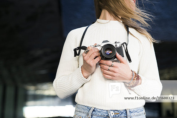 Young woman with camera  partial view