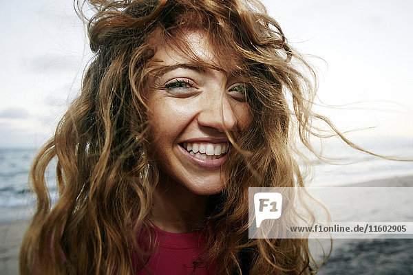 Wind blowing hair of Caucasian woman on beach