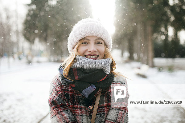 Caucasian woman smiling in snow