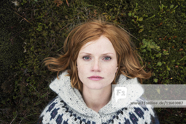 Portrait of Caucasian woman laying on moss