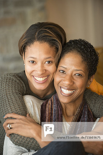 Portrait of smiling Mixed Race mother and daughter