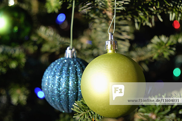 Blue and green ornaments hanging on Christmas tree