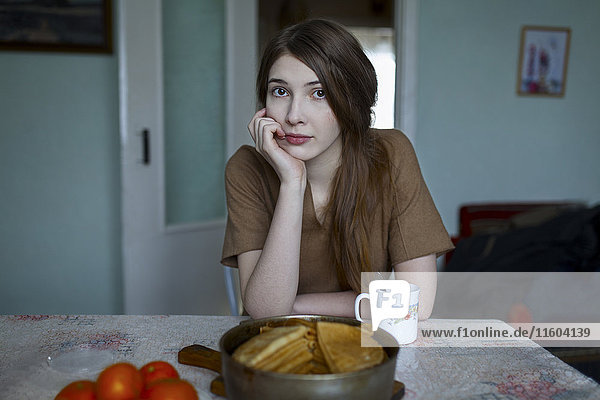 Pensive Caucasian woman sitting at table