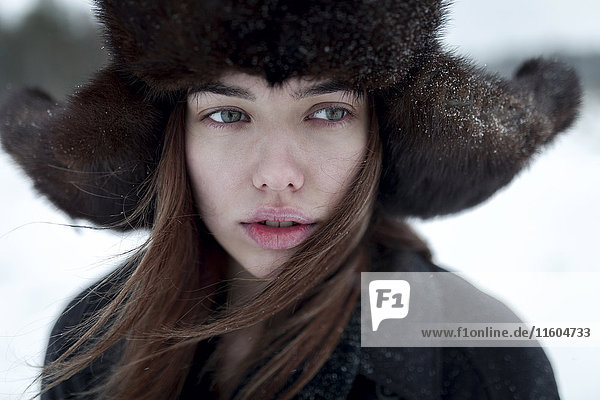 Serious Caucasian woman wearing fur hat and coat in winter
